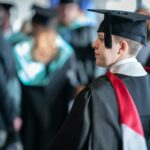 A graduate facing the stage at our Higher education graduation ceremonies.