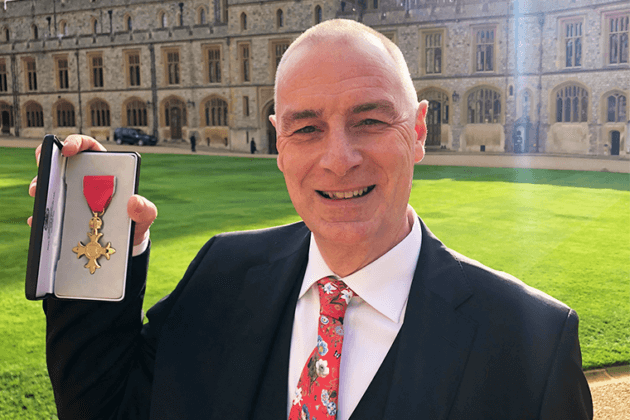 Rob Lawson. Govenor for RNN Group with his OBE outside WIndsor Castle.