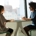 Two people sat at a table talking