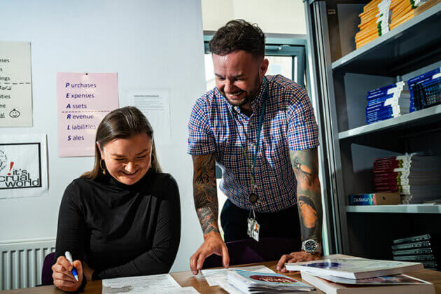 An adult learner talking to a lecturer