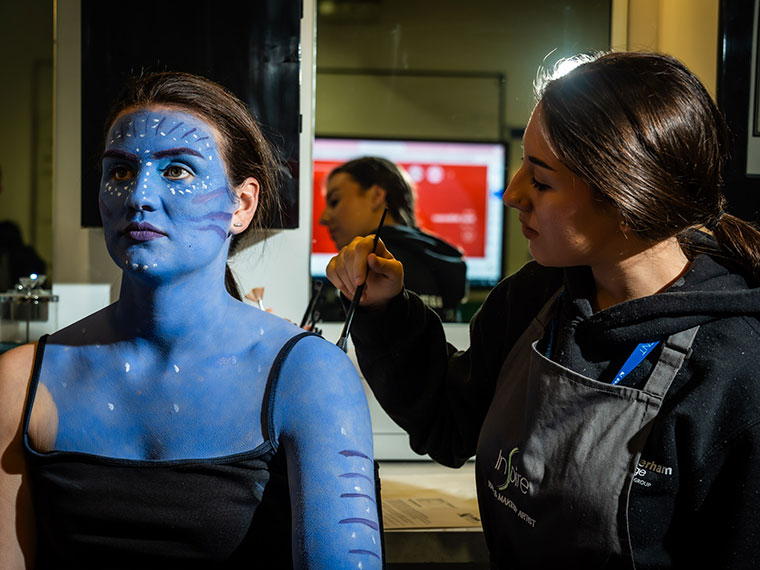 A media make up student working on a client