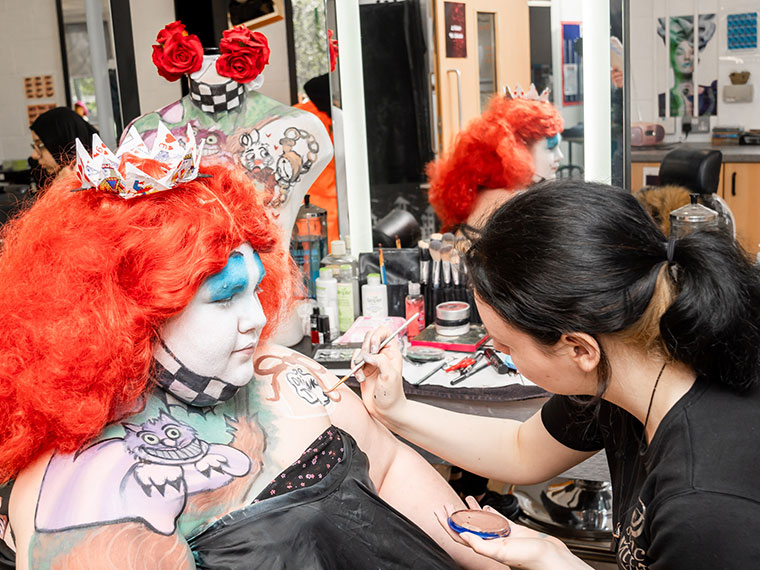 A media make up student working on a client