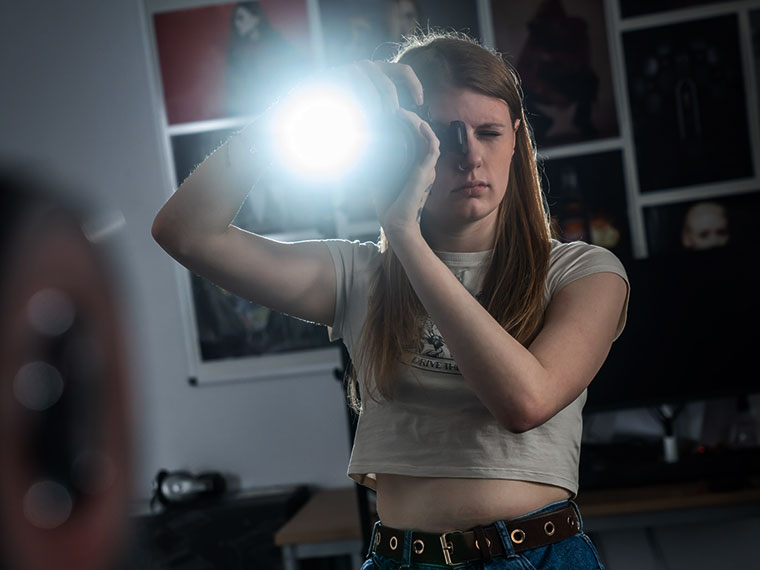 A photography student holding a camera