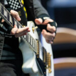 Close up of a student playing the guitar