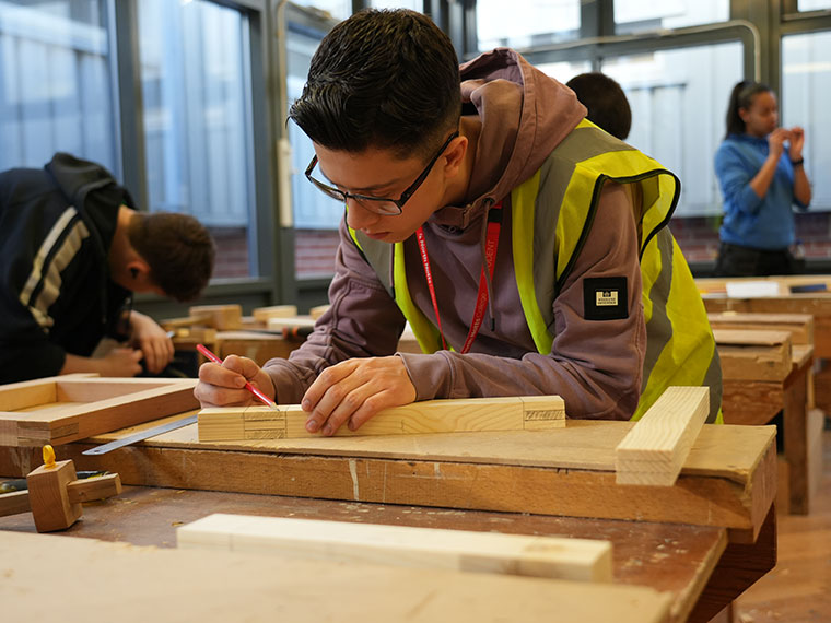 A student working on a project in the NNC joinery workshop