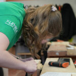 A joinery student working at a bench