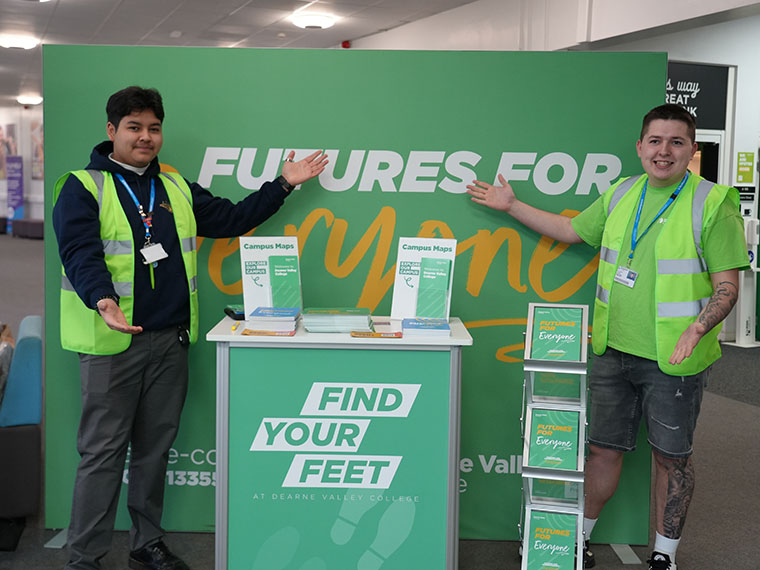 Two people stood next to the 'Futures For Everyone' Dearne Valley College banner