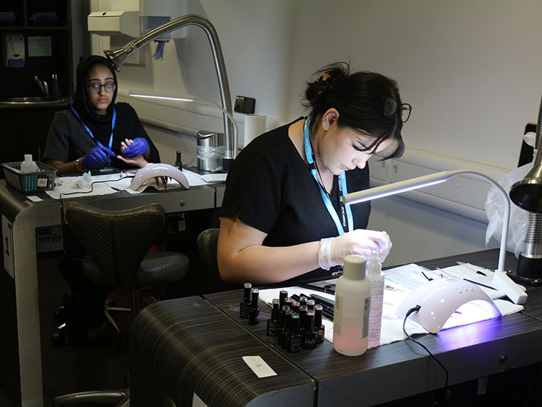 A student working on some nails during the Intercollege 2025 competition