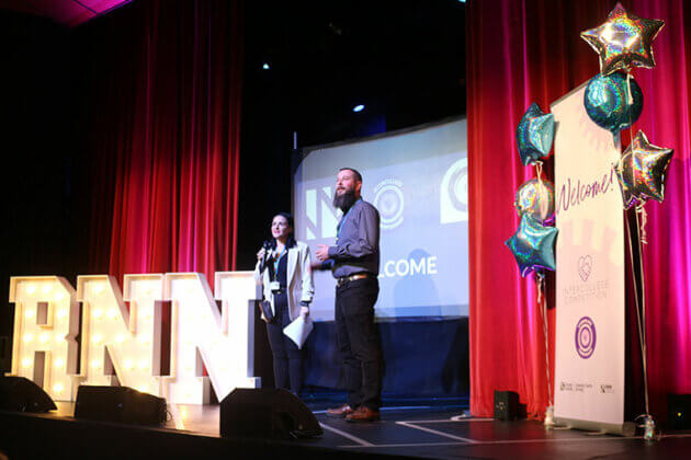 Members of staff on stage welcoming people to the Intercollege 2025 competition