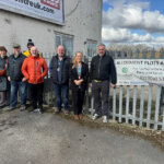 A group of people helping to bring a project together with North Notts College construction students and Bassetlaw District Council