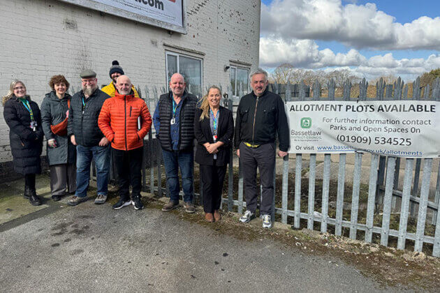 A group of people helping to bring a project together with North Notts College construction students and Bassetlaw District Council